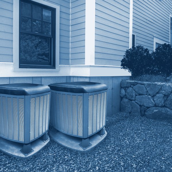 Air conditioner units beside a house
