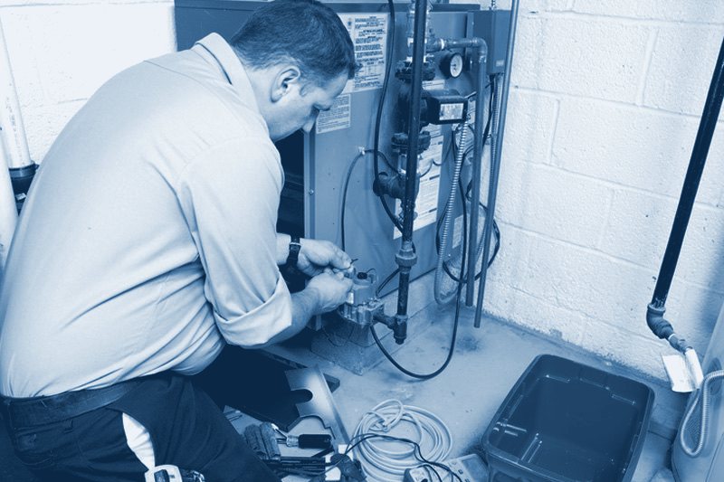 Technician servicing a furnace